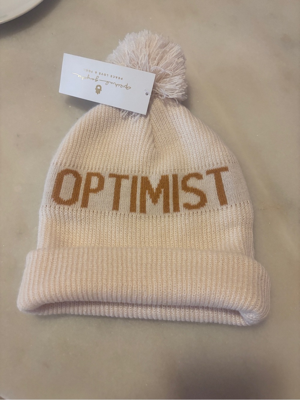 NWT Spiritual Gangster “ETERNAL OPTIMIST" Pom Beanie - Cream with Tan Lettering